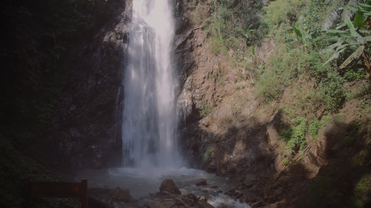 Peaceful waterfall in lush Chiang Rai forest, serene natural beauty