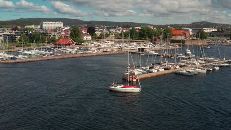 sailboat leaving harbour of kristiansand in norway