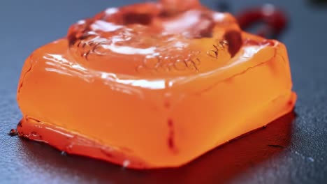 exploring the transformation of gelatin: from solid orange to bubbling red delight in two captivating frames