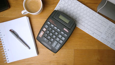 Calculator-falling-on-office-desk