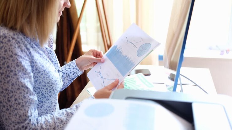 Woman reviewing business chart and data report