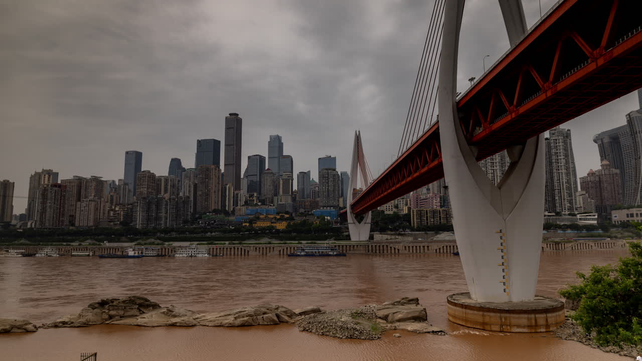Timelapse of the amazing Chongqing cyberpunk city skyline from a high vantage point wirh the yangtze river at sunset