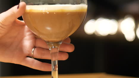 female hand grabs drink, close up