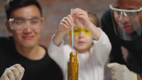 serious student drips reagent into flask flowing out foam