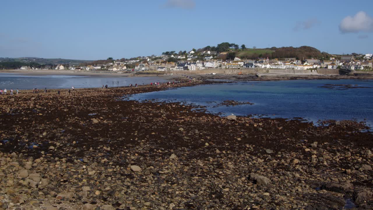 wide shot looking over Saint Michael's mount Causeway with Marazion in the background