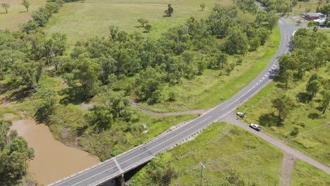 vehicles navigate roadwork on a bridge over water