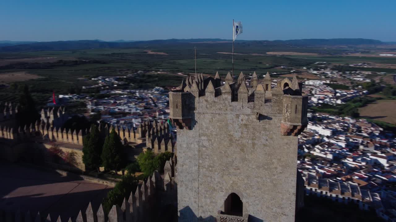 Tower and flag of Almodobar del R&iacute;o Castle, Drone shot 4k, cordoba
