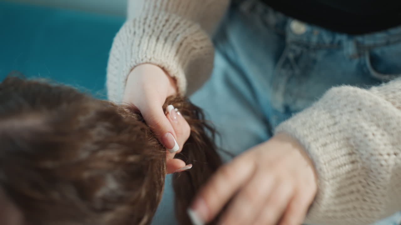 Casual Hairdo On Couch, Relaxed Scene With Hair Styling Process, Closeup Of Hands Arranging Shiny Hair In Ponytail, Comfortable Setting Where Friend Styles Hair Casually Near Window