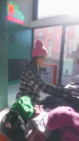 volunteer sorting clothes at donation center