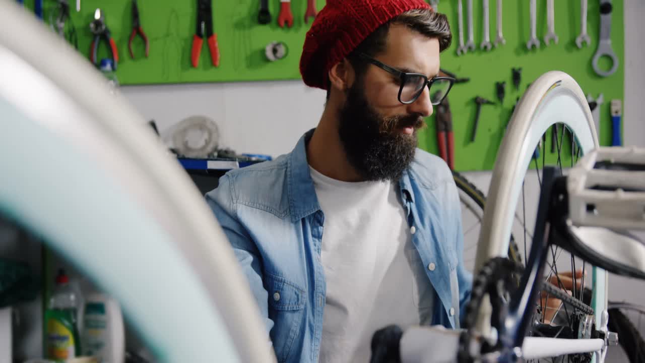 Mechanic repairing bicycle in workshop