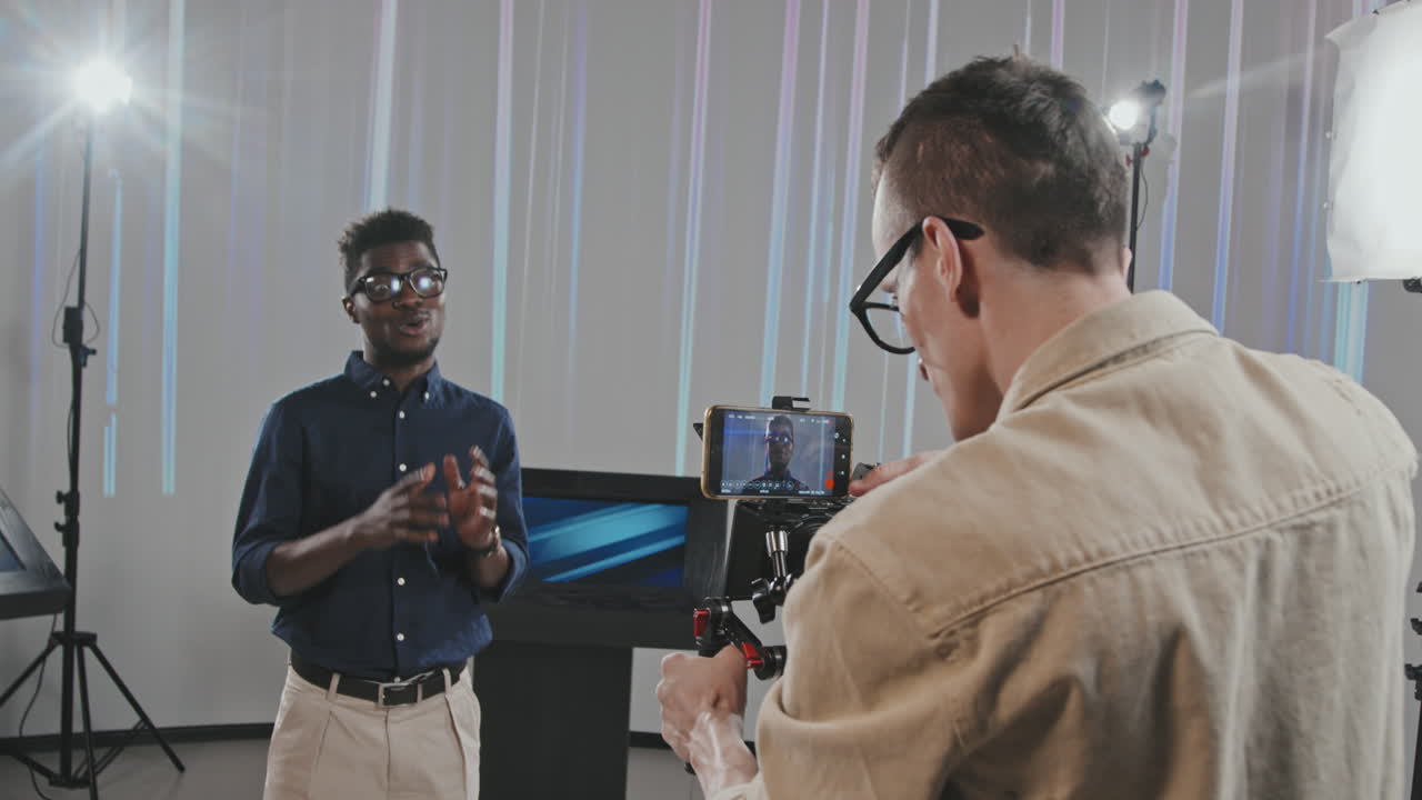 Operator And African American Man Filming Commercial In Studio