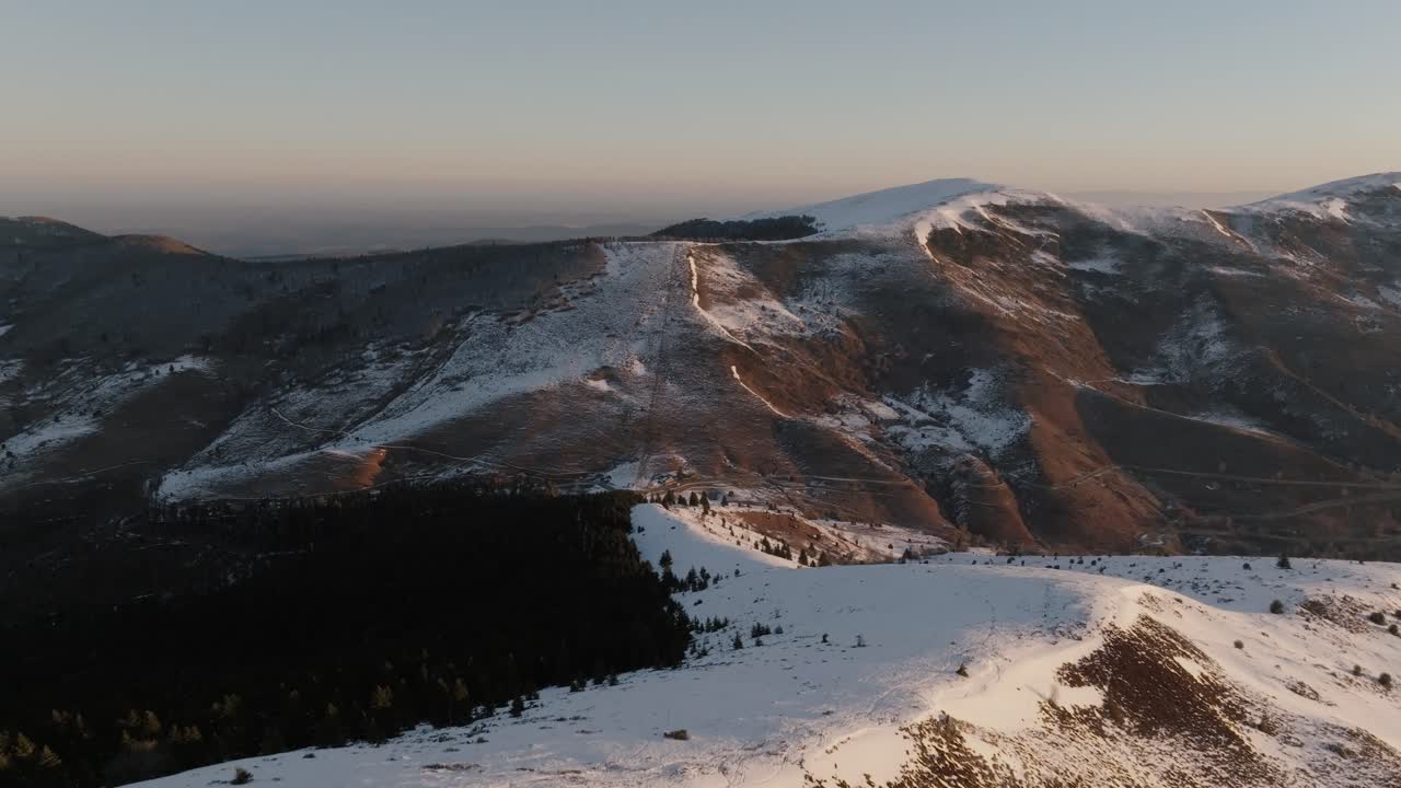 Explore the tranquil beauty of Pyrenees mountains at sunrise with aerial drone footage, golden hues.
