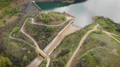 Drone-Video-Dam-revealing-lake-mountain-forest-country-road