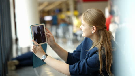 Mother-with-pad-taking-pictures-of-her-son-in-the-waiting-room