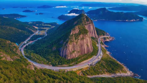aerial view of a scenic coastal highway winding around a mountain