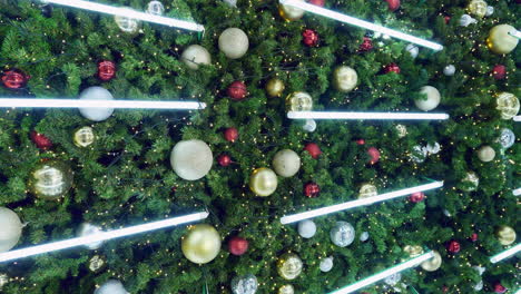 vertical shot of glimmering christmas decors with its glittering lights in front of a shopping mall in pattaya, in chonburi province in thailand