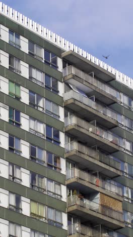 slow motion of concrete social housing block with passing bird evoking poverty and urban struggles