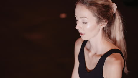 Slow-Motion-Of-Attractive-Fit-Female-Athlete-Meditating-At-Health-Club