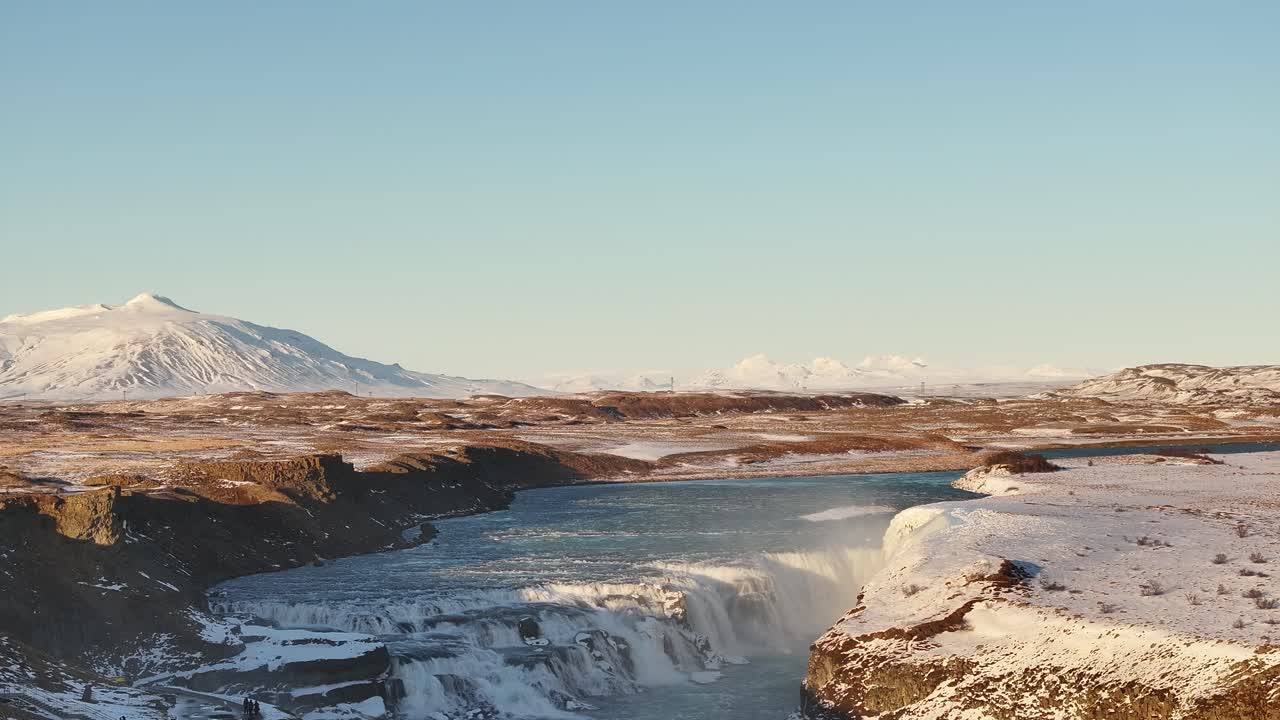 Gullfoss waterfall over Hvítá River with snowy peaks in Suðurland Iceland