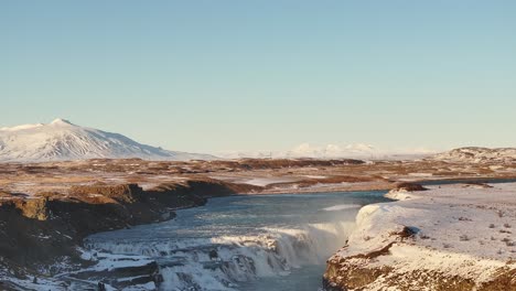 gullfoss waterfall over hvítá river with snowy peaks in suðurland iceland