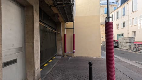 pedestrians walking through a narrow parisian street