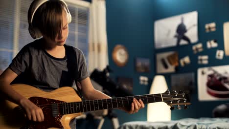 youngster with guitar in bedroom