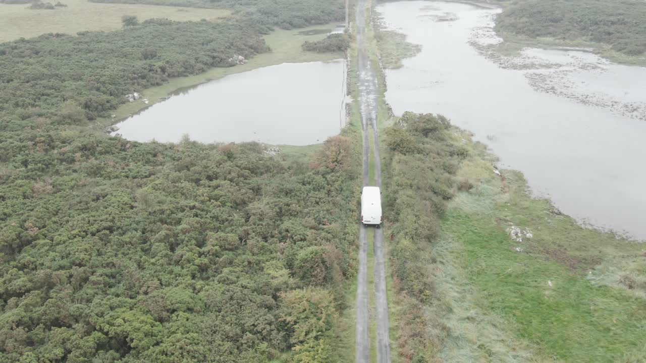 Above View Of A Van Driving Across Narrow Rural Road In County Limerick In Ireland. Aerial Shot