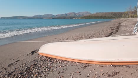 upturned leisure boat on sunny sandy mediterranean deserted beach