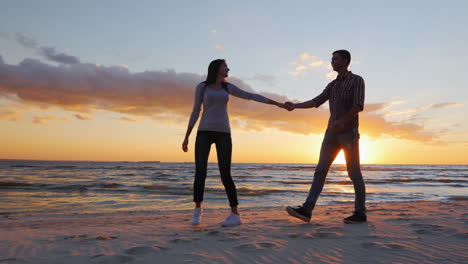 loving couple walking at sunset on the beach or lake she leads the guy flirting prores hq 10 bit vid