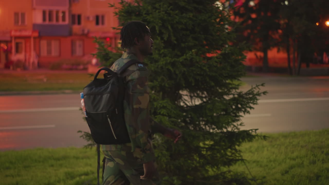 Night Sentinel Alertness, Urban Guardian Watches Traffic Skilfully, Vigilant Observer Stands Quietly By Roadside, An Attentive Scout Pauses Beneath Glowing Signs To Monitor Vehicle Flow