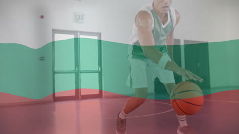 animation of flag of bulgaria over biracial male basketball player at gym