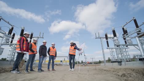 engineers supervise the construction of a transformer substation