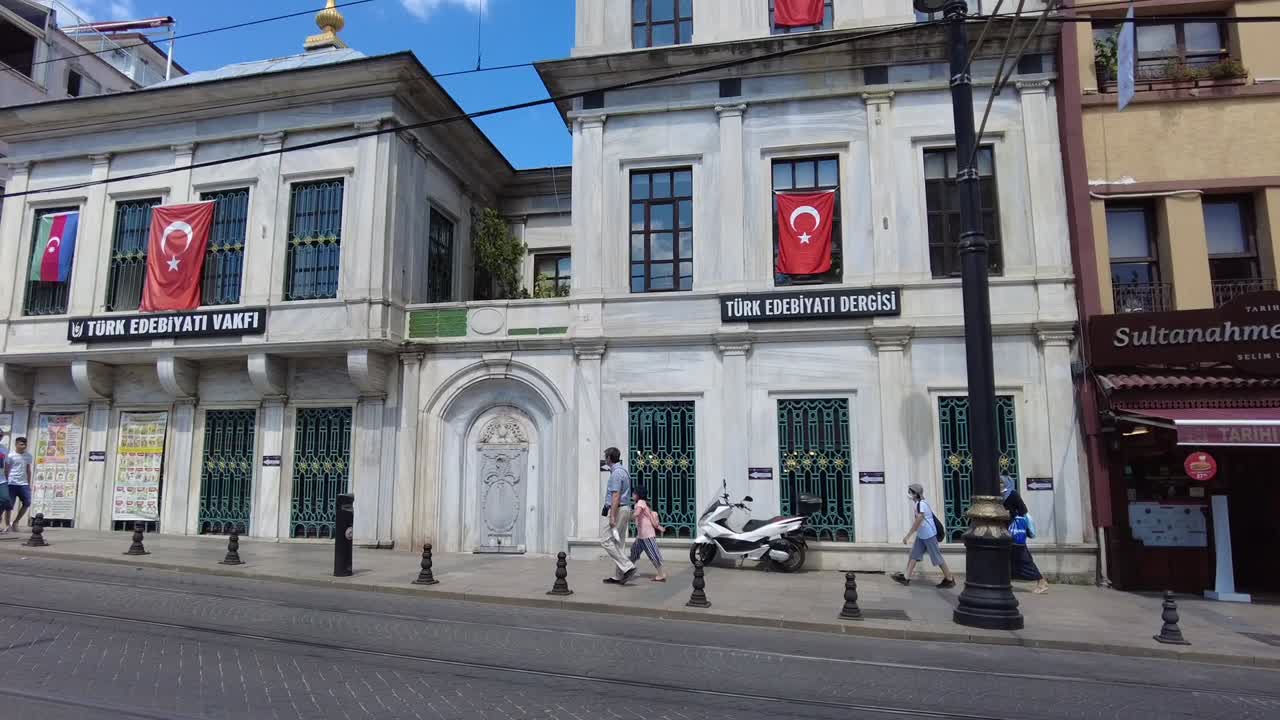 Pedestrians walking through the vibrant Sultanahmet neighborhood in Istanbul, Turkey. The historic district, filled with iconic landmarks, offers a lively atmosphere blending culture and history.