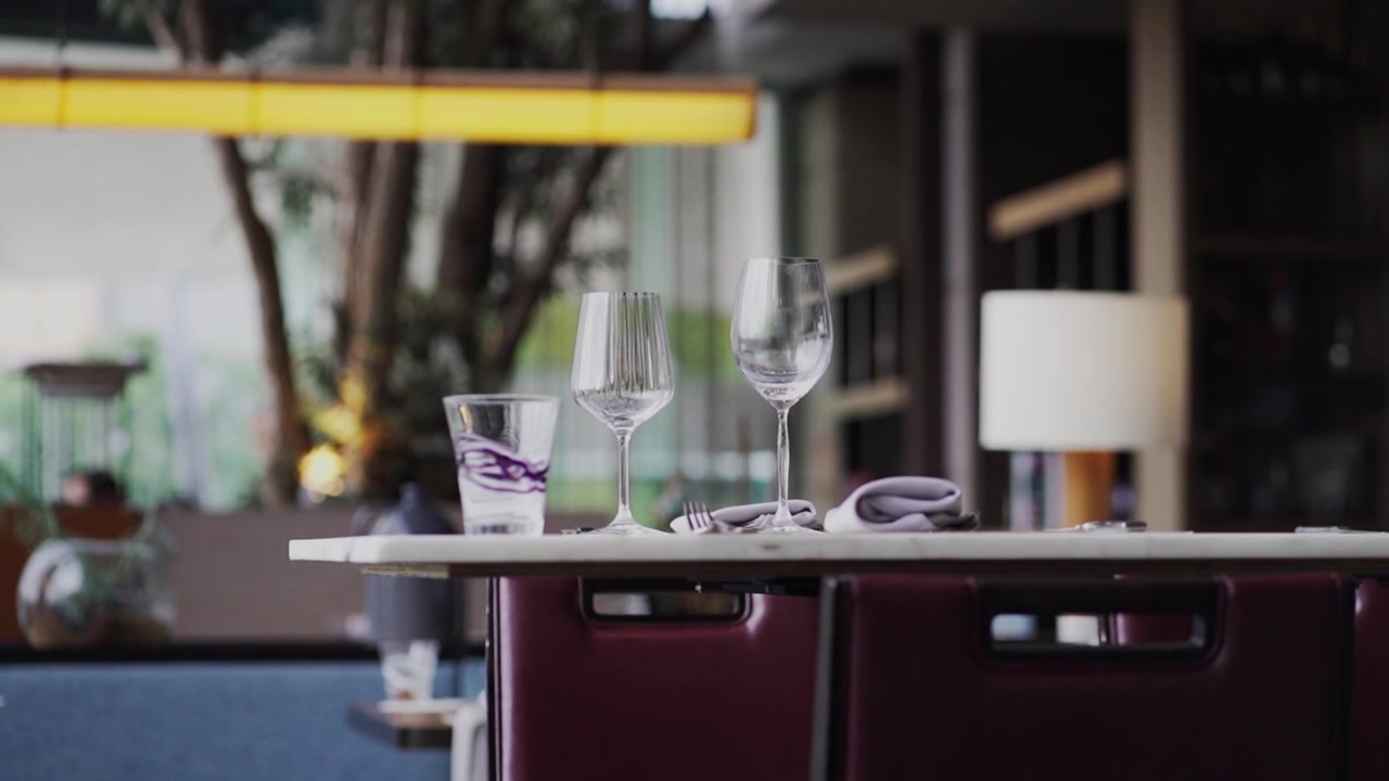 Table set for two in nice restaurant. Static medium shot