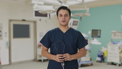 indian doctor removing stethoscope from shoulders