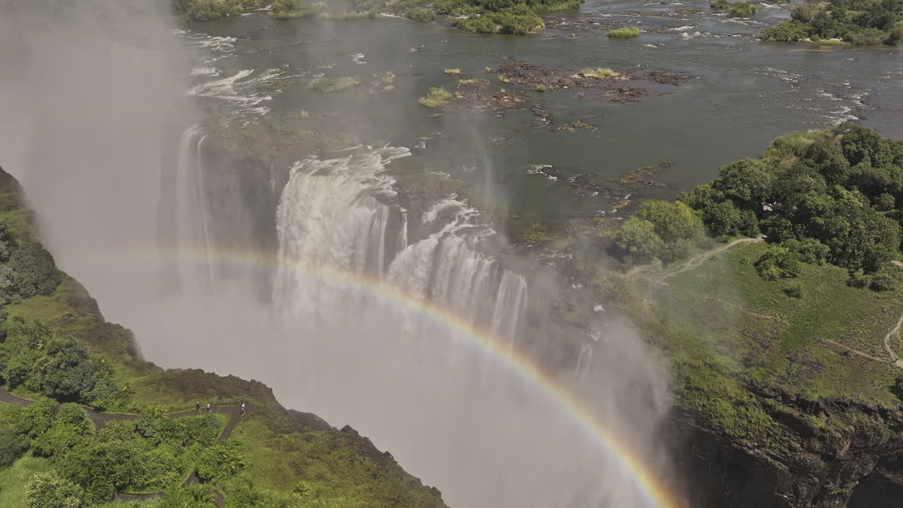 Victoria Falls Zimbabwe Aerial v6 birds eye view flyover Zambezi river capturing epic cataract waterfall plunging over the cliff, misty veils and rainbows - Shot with Mavic 3 Pro Cine - Jan 3rd 2024