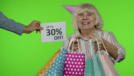 advertisement up to 30 percent off appears next to grandmother. woman dancing with shopping bags