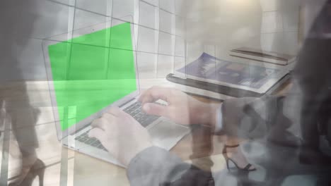 animation of hands using laptop with green screen over sped up commuters walking in modern building