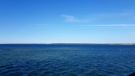 view of the ocean and clouds in the sky. blue sky with clouds in sunny weather over the ocean.