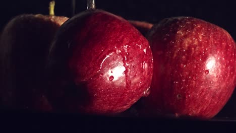 water droplets splashing on red apples in slow motion-1