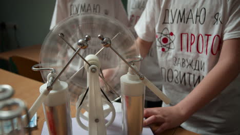 close up unrecognizable students experimenting in physics class.schoolchildren