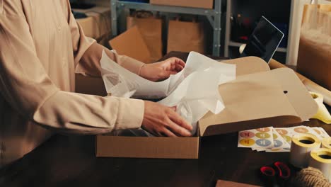 Woman Packaging a Gift or Order