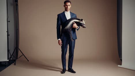 man in suit holding a tenrec