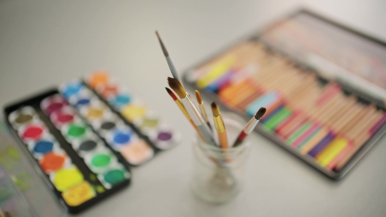 Close up of a watercolor palette with vibrant colors arranged in rows