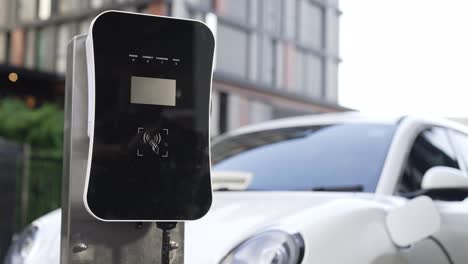 progressive innovation urban electric on-street charging station with ev car.