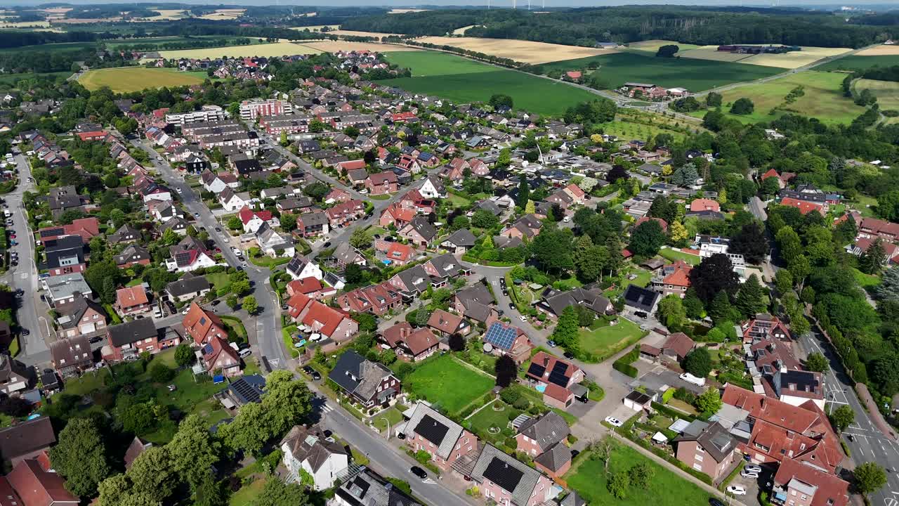 Solar panels on roof of houses and homes in American city. Sunny day in summer. Aerial wide shot. Peaceful and calm small village in United States. Renewable energy production
