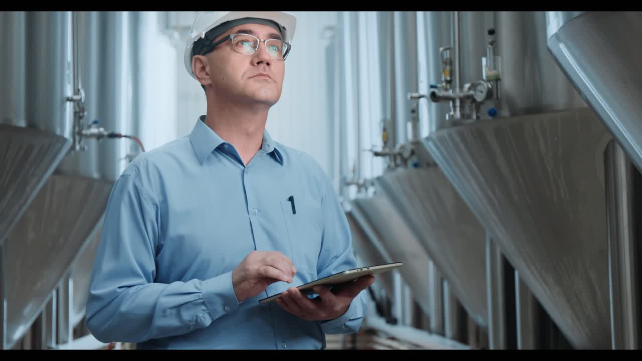 Engineer using tablet in a brewery