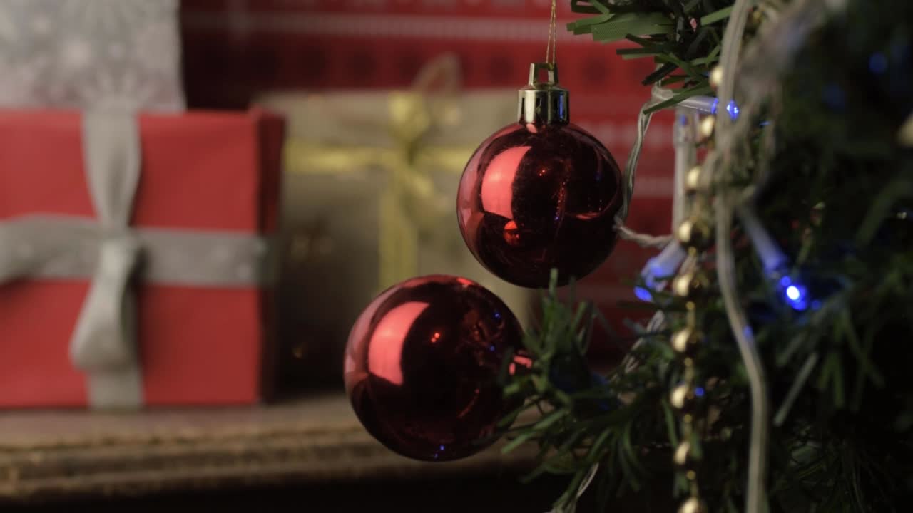 View of wrapped Christmas gifts through Christmas tree
