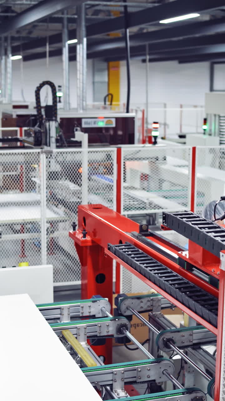Industrial robot working in factor. Manufacturing of solar panels in factory Vertical video