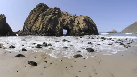 Lapso-De-Tiempo-De-ángulo-Bajo-De-Olas-Rompiendo-A-Través-De-Una-Roca-En-La-Playa-De-Pfeiffer-En-Big-Sur-California